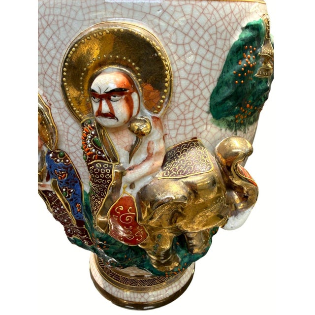 Striking vintage Japanese Satsuma-style moriage vase featuring elaborate raised-relief decoration depicting robed figures,...