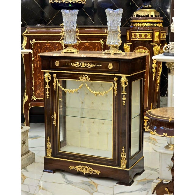 Showcase your most treasured collectibles in timeless French elegance with this exquisite French Louis XVI Display...