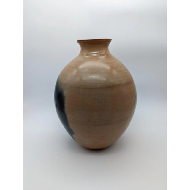 Stunning vase in neutral colors of clay and black. Gorgeous craftsmanship, stunning shape and an extremely tactile finish....