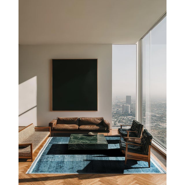 A hand-knotted wool rug in the Moroccan idiom, made in India and measuring 9' x 12'. Moroccan design leans on open ground...