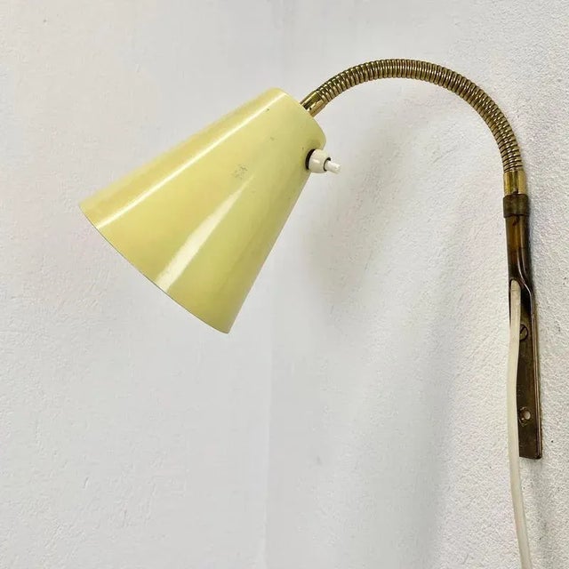 Article: wall light with yellow shade Origin: Italy Age: 1950s This modernist light was produced in Italy in the 1950s in...