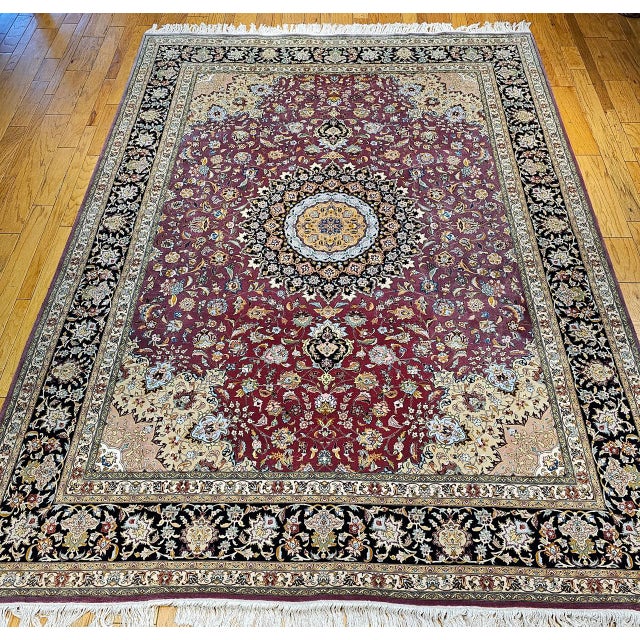 "This exquisite vintage Persian Tabriz room-size rug, woven in the fourth quarter of the 1900s, is a testament to the...