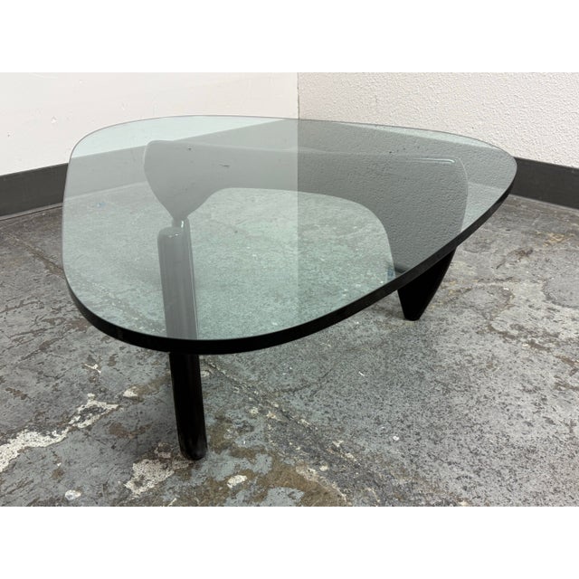 Design Plus Gallery presents a Vintage Noguchi Glass Top Coffee Table by Isamu Noguchi. Originally designed in 1948, this...
