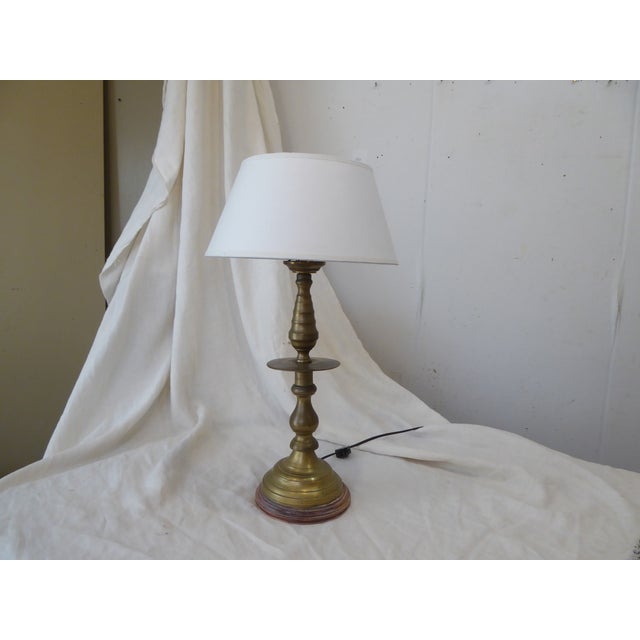 This solid brass candlestick lamp has an old patina, a weathered wood base and looks goo with a 12" Diameter bouillotte...