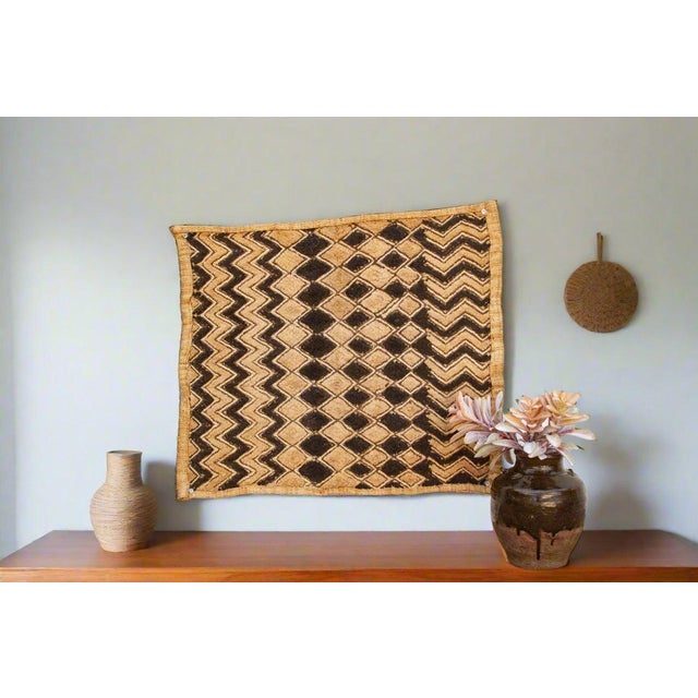 A captivating masterpiece of African textile art, this vintage Kuba cloth panel is a testament to the unparalleled...