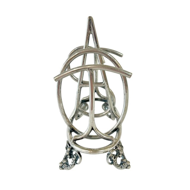 The most sought after toast rack design! Spells out toast. This piece is marked EPNS England with a makers mark that reads...