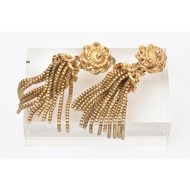 These stylish vintage signed Schiaparelli dangle clip on earrings are braided tops with tassels hanging. The tassels hang...