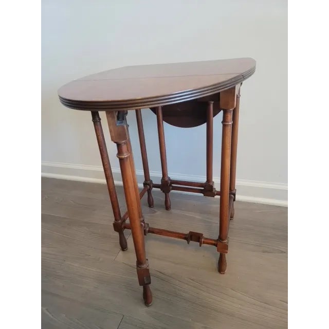 This 19th-century, Victorian Sutherland, drop-leaf table is made of hand-carved, solid walnut. The Gateleg design feature,...