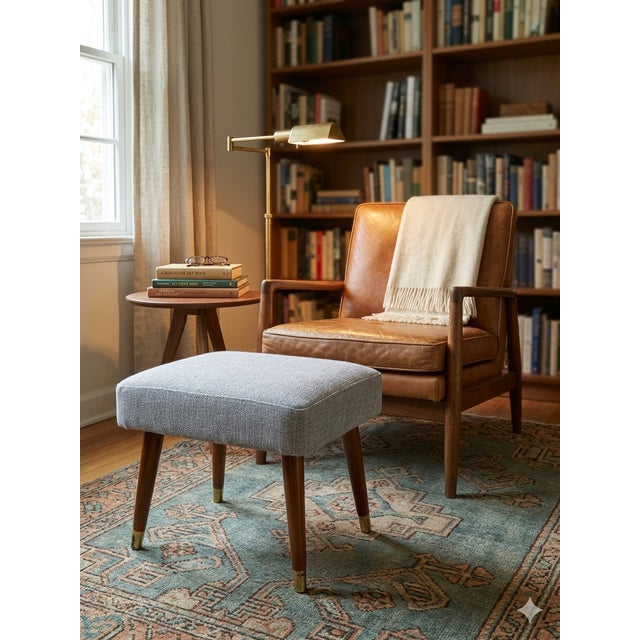 Elevate your space with this classic piece of mid-century design. This versatile footstool features beautifully sculpted,...