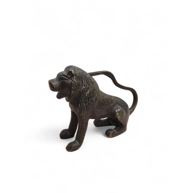 Charming 19th-century bronze sculpture depicting a seated lion, one of the most enduring symbols of strength, vigilance,...