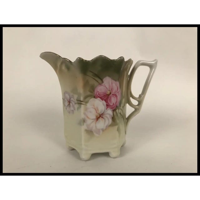 Beautiful hand painted porcelain creamer, by Burley & Tyrrell co. from Germany. Lovely floral motif painted against a pale...