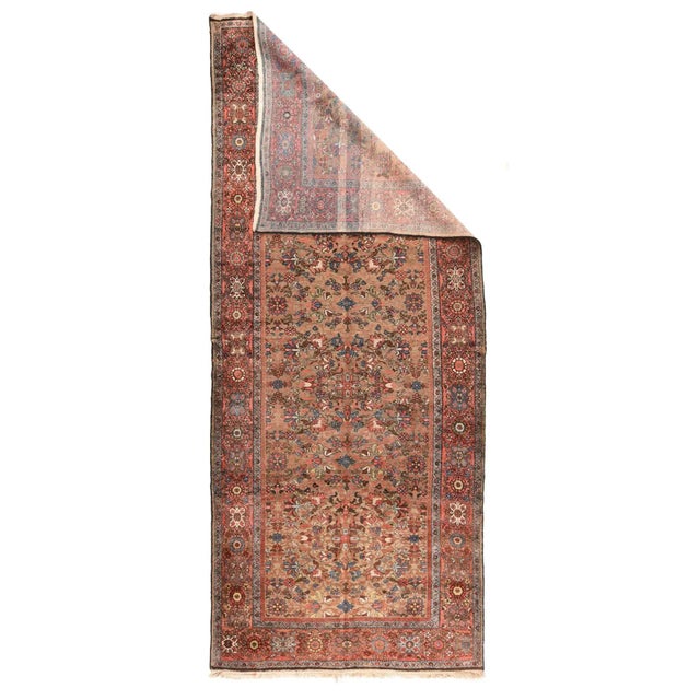 The noticeably abrashed salmon-camel field shows a fairly close pattern of palmettes, rosettes, pointed small crosses and...