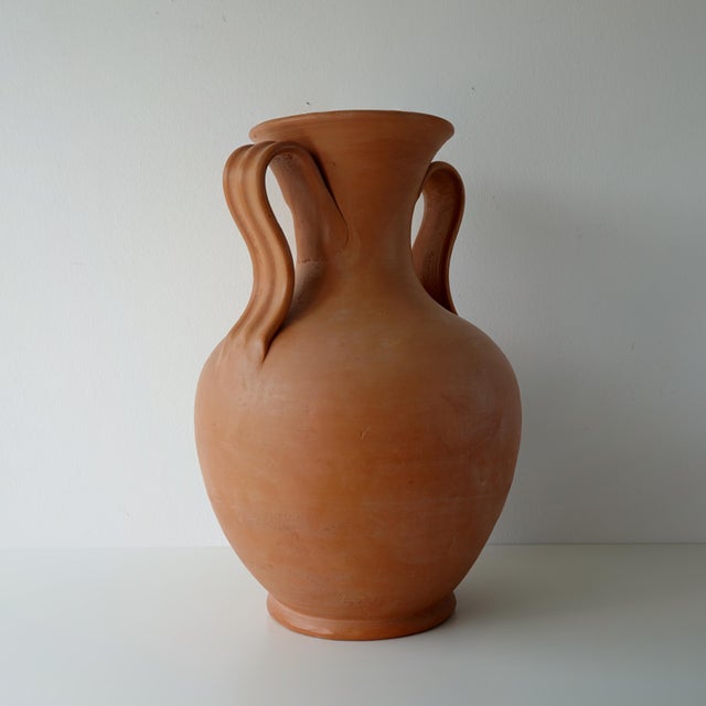 Vintage circa 1980s Italian terracotta amphora vase. This ceramic hand thrown large vase has two sculptural ribbon style...