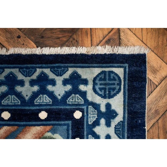 Hand-knotted Chinese rug from the late 19th century. Beautiful motif of storks with trees. The rug is knotted from high-...