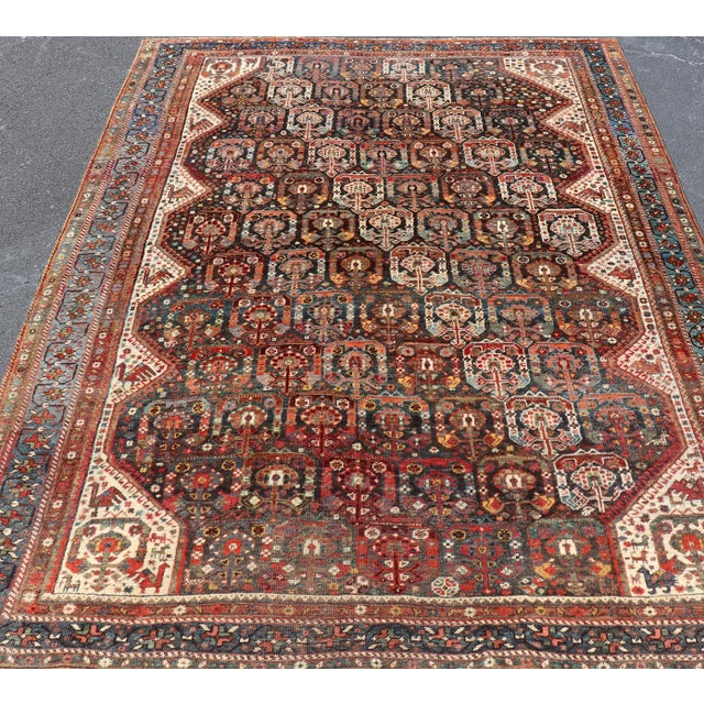 Measures: 6'10"X9'3" Antique Persian Qashqai Rug with Intricate Tribal Motifs and Rich Color Palette 6'10"x9'3". Keivan...