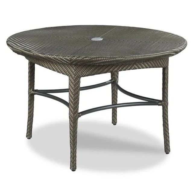 A round woven top is mounted to a woven base with four rounded tapering legs. Powder Coated Aluminum with Handwoven...