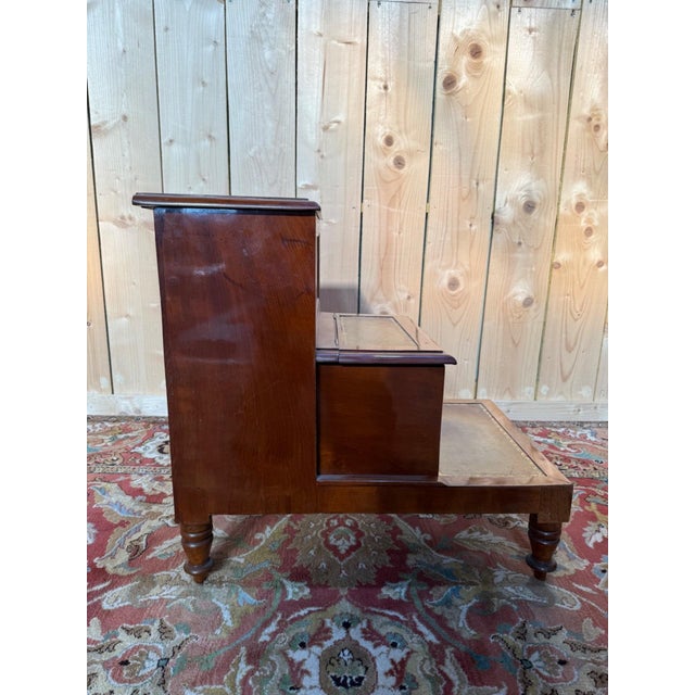 Three-step English mahogany library staircase with built-in storage chests beneath a hinged-lidded step. Constructed in...