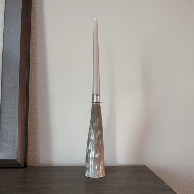 Vintage sculptural taper candle holder crafted from natural horn with silver tone metal detailing. The elongated, gently...