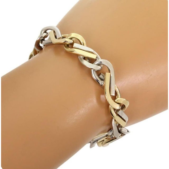 This is a bold men's bracelet, crafted from 14k yellow and white gold, it features two tone gold joined to form an...