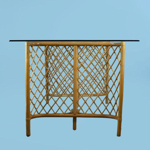 A vintage lattice rattan dining table, its open latticework base giving the generous seventy-two-inch top a light,...