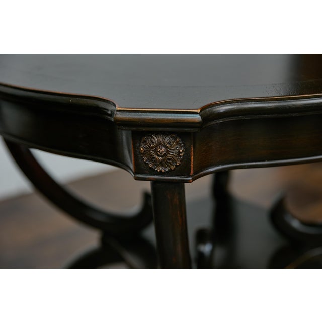 This pair of English midcentury round side tables exudes timeless elegance with their dark, nearly black-brown finish and...