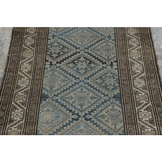 Hand-knotted in wool, this 3x4 antique rug is a finely detailed example of Persian Malayer weaving, dating to circa...