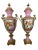 A pair of french sèvres marked monumental pink vases with hand painted scenes depicting french lovers dining at a garden...