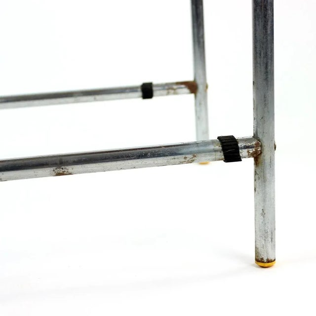 Great side table in chrome construction with top board in wood, finished with formica in light gray color. The table was...