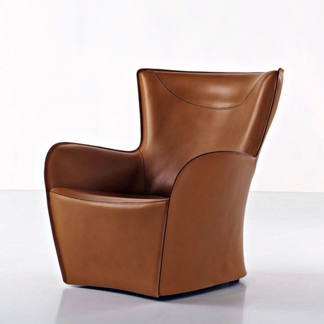 Add a touch of elegance to your home with this Molten &C. lounge chair. Featuring high-quality brown leather and a modern...