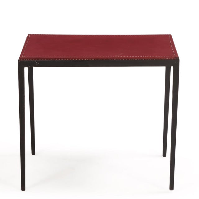 A sophisticated, handcrafted side table inspired by the refined minimalism of Jean-Michel Frank. This table features a...