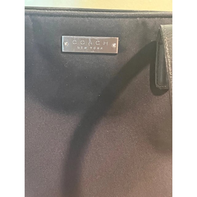 Up for sale is an authentic vintage Coach tote shoulder bag crafted in durable black nylon with genuine black leather...
