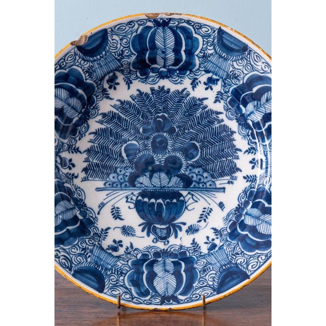 Diameter: 31 cm Height: 6 cm Some chips and glaze losses to the edge. Marked for the De Klaauw factory underneath.