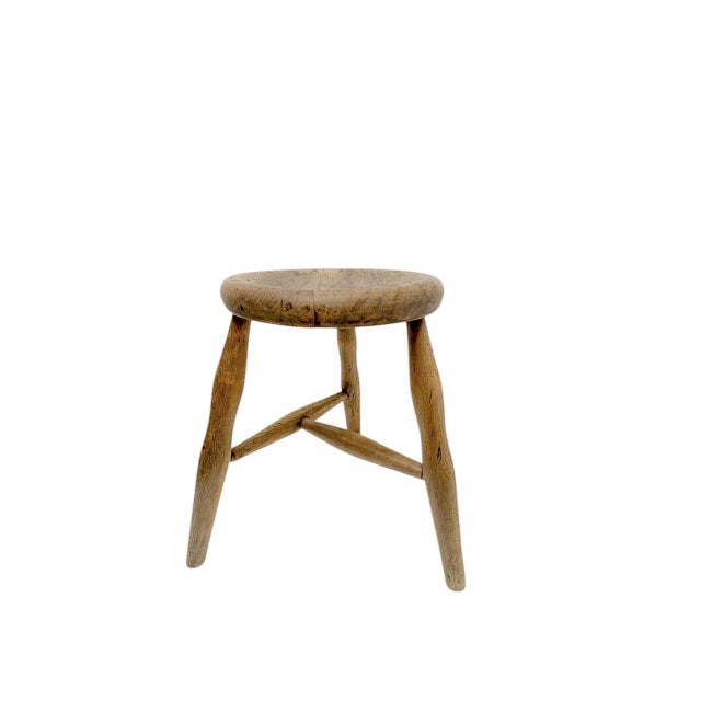 Mid-Century Workshop or farmhouse stool in a warm-soft brown color of wood. Old handicraft with a slight convace in the...