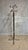 A distinctive vintage freestanding coat rack combining a dark wooden central column with polished chrome-plated metal...