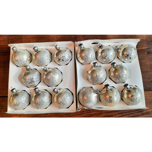 Hand-blown glass Christmas ornaments in silver cream white with glitter, all in their original boxes. We have two complete...