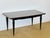 This elegant 1950s dining table captivates with its typical post-war modernist design. Its rectangular top features a...