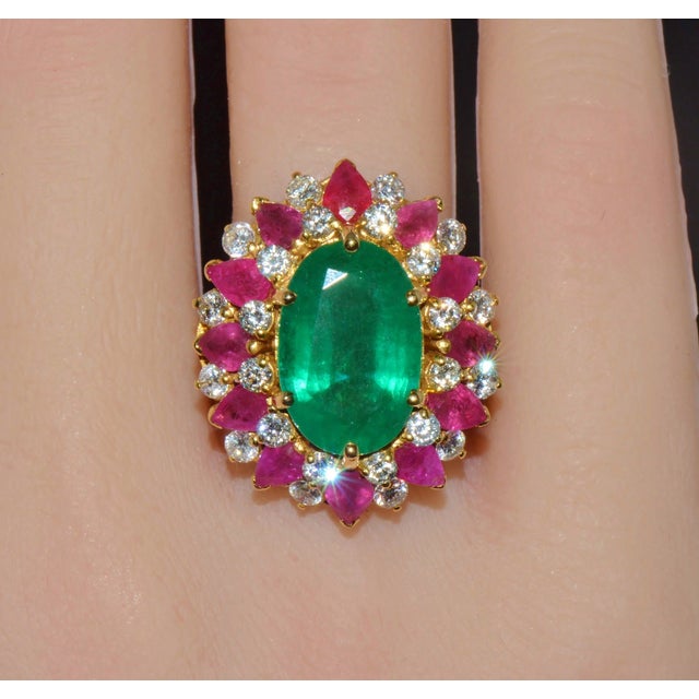 This magnificent ring features a 7.35CT GIA certified natural emerald, surrounded by 12 pear-cut natural rubies totaling...