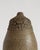 A single-stem ceramic vase with a tall, rounded body and a gently narrowed neck, defined by an exceptionally tactile...