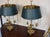 Pair of French Empire style bouillotte table lamps dating to the 1960s. Each lamp has three curved brass arms with candle-...