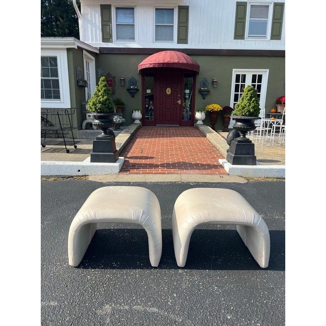 Pair of Post Modern Ottomans. Classic 1980's style . Off white with a cream satin design finish. Similar to: Milo Baughman...