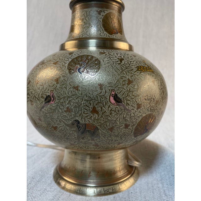 Vintage Indian table lamp made of incised brass and enamel featuring a finely detailed animal motif. This stunning lamp...