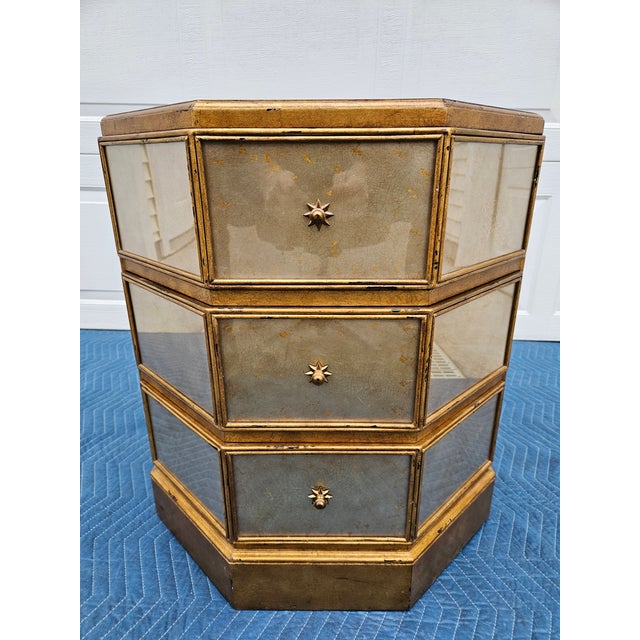 This octagon shaped Venetian style side table is by Theodore Alexander and features an Eglomise style gilding on the...