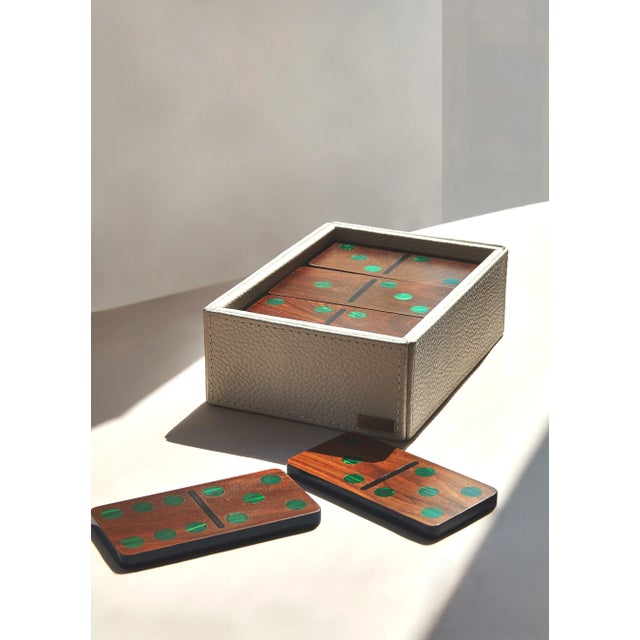 Our Large Domino set is composed of 28 pieces of Pui wood with malachite inlay. Each piece is outlined in blue...