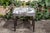 A French steel bench from the mid-20th century, with out-scrolling arms, tapered legs and classical-themed toile...