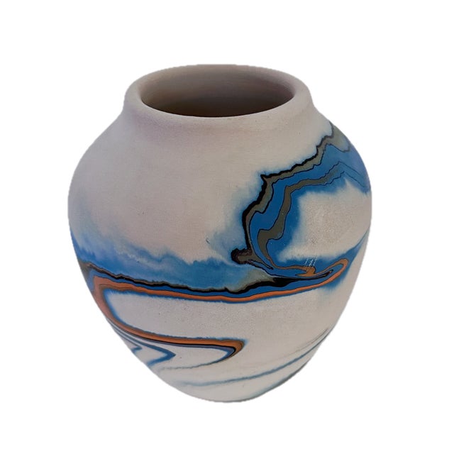 Vintage American Nemadji ceramic vase in traditional cream matte glaze and painted with blue and orange swirls. The vase...