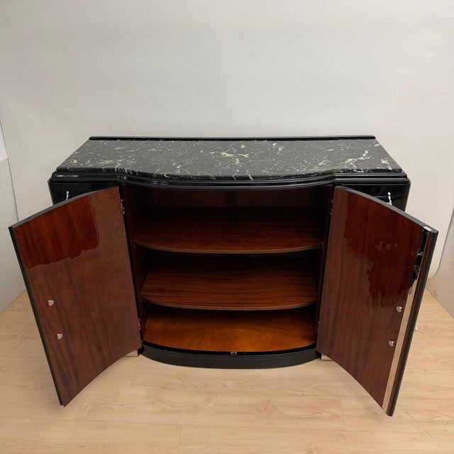 High-quality, fully restored original Art Deco sideboard in black piano lacquer with original metal hardware and a marble...