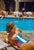 Poolside In Capri by Toni Frissell A chic,swimsuited holiday maker poolside in Capri, Italy, 1959. (Photo by Toni...