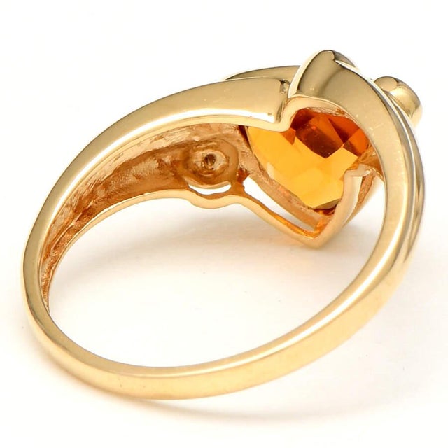 Set in a darling yellow gold ring, a magnificent bezel-cut citrine captures the eye. Full-cut diamonds add sparkle that...