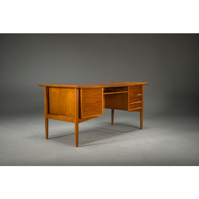 Elegant danish teak executive desk designed by arne vodder for h.p. Hansen in the 1960s. Featuring the designer’s...