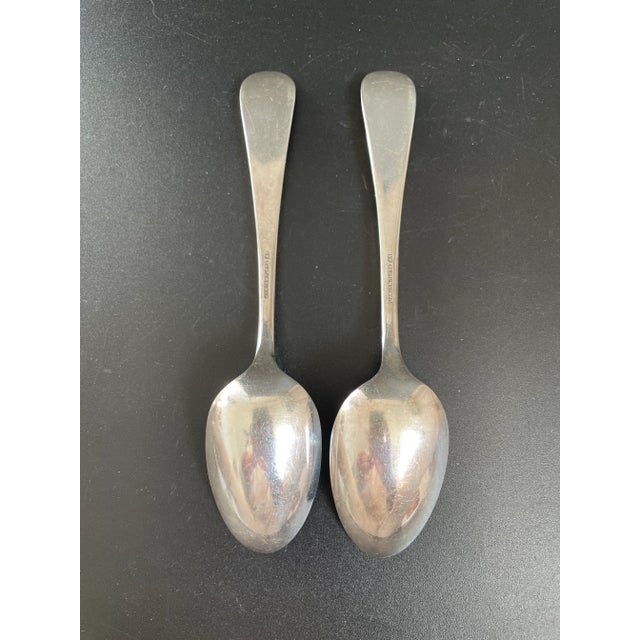 A set of two antique James W. Tufts A1 silverplate teaspoons in the "Shell" pattern. The tip of handle features a monogram...